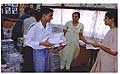 A National Open School student interacting
	with the Principal while carrying home the 
	books which have been given to him.
